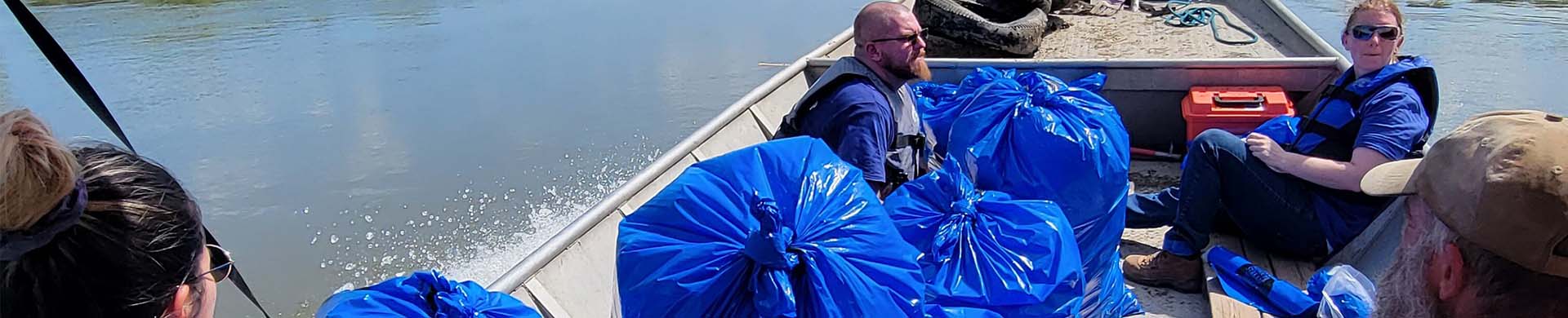Volunteers Hauling Trash Out of River
