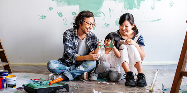 Couple and Child Sitting on Floor Painting