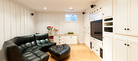 Finished basement media room with leather couch