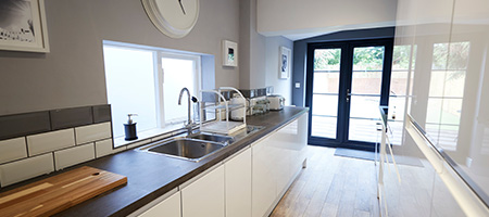 A light hardwood floor adds space to a galley kitchen makeover.