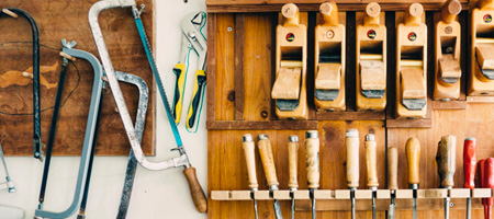 Outdoor tools hanging on a garage organization board