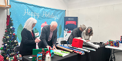 Volunteers Wrapping Gifts for Genesis Shelter
