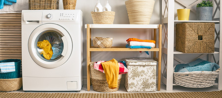 Organized Laundry Room With Small Washer and Plants