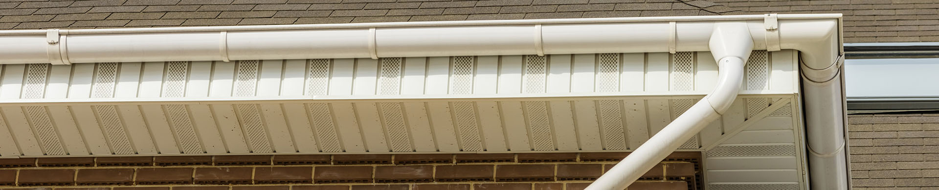 White Gutter Against Brown Roof