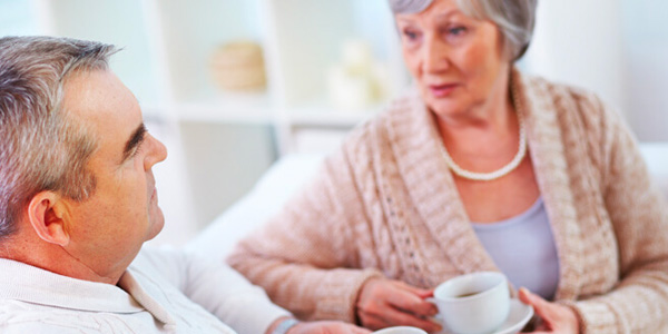 Couple With Coffee Cups Having a Serious Conversation