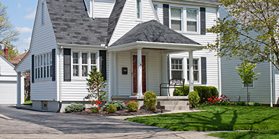 White Urban House With Green Lawn