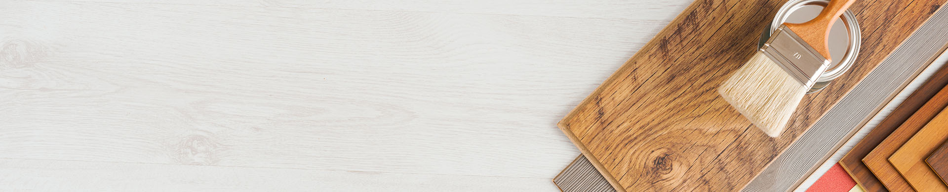 Paintbrush, Roller, Keys and Wood Laminate on White Wood Background