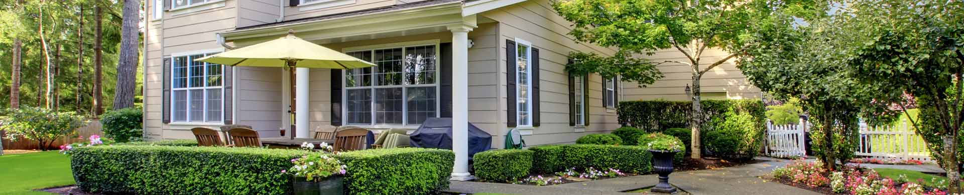 Large Beige House With Green Lawn