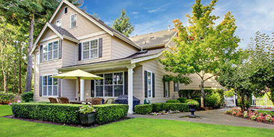 Large Beige House With Green Lawn