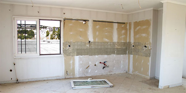 Home Undergoing Renovation With Exposed Ceiling and Wall Outlets