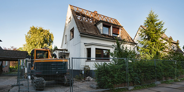House Demolition With Fence and Excavator