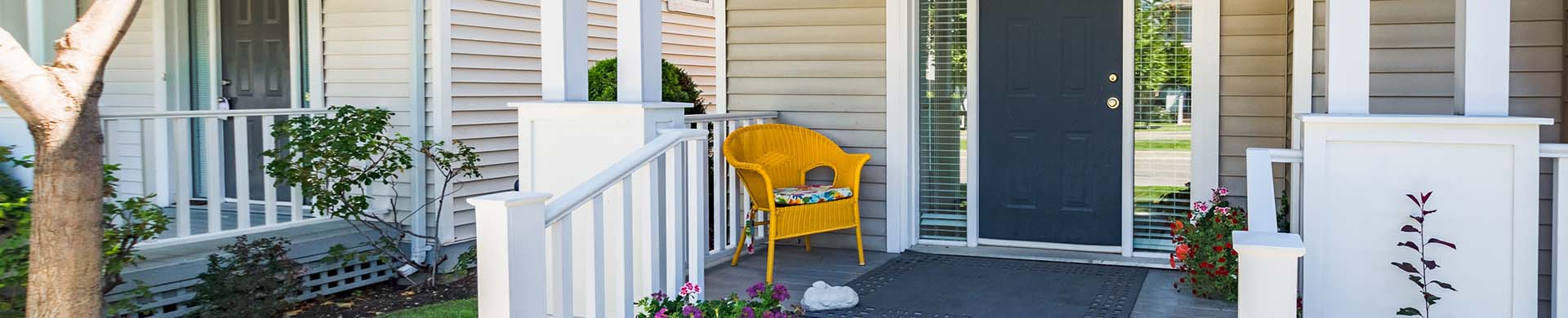 White Front Porch Decorated With Potted Plants