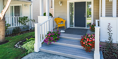 White Front Porch Decorated With Potted Plants