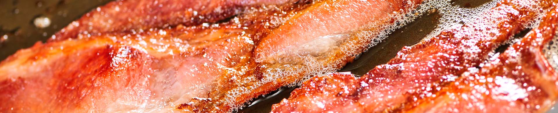 Bacon Cooking in Pan with Hot Grease