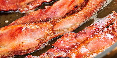 Bacon Cooking in Pan with Hot Grease