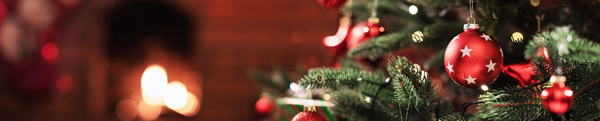 Close-Up of a Decorated Christmas Tree in Front of a Fireplace