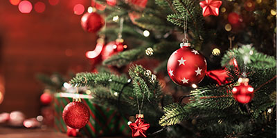 Close-Up of a Decorated Christmas Tree in Front of a Fireplace