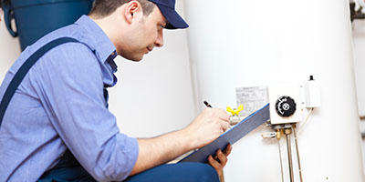 Man Inspecting Water Heater