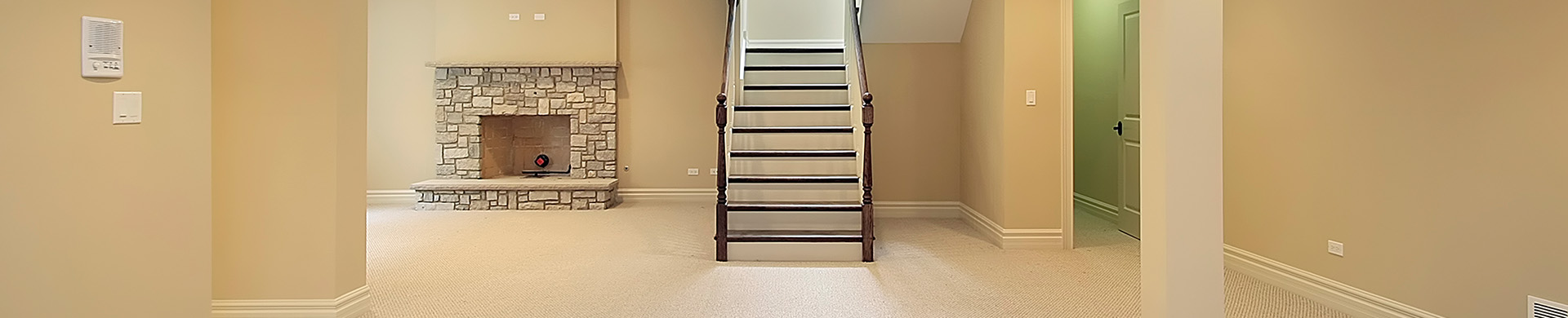 Empty Basement With Steps and Fireplace