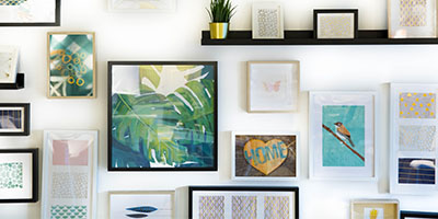 Multi-Size Picture Frames Hung on White Wall