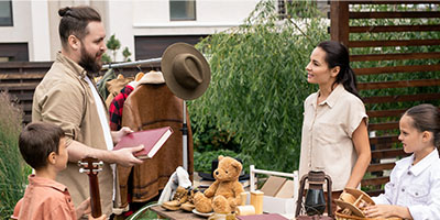 People Looking At Household Items at a Garage Sale