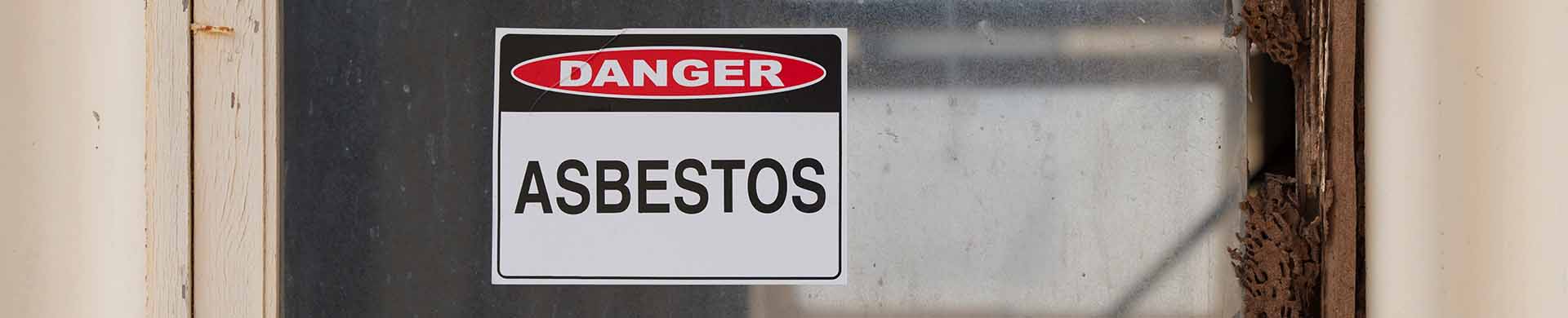 Asbestos Danger Sign on Window With Broken Sill