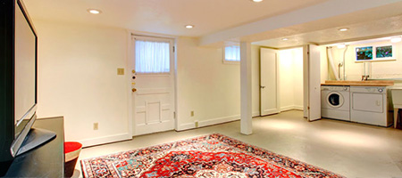 Semi-Finished Basement Media Room With Laundry Machines in Back