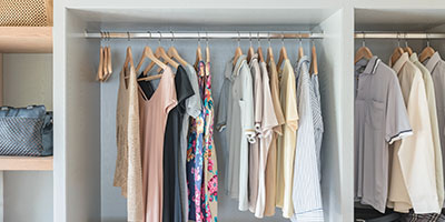 Organized Closet With Shirts on Hangers