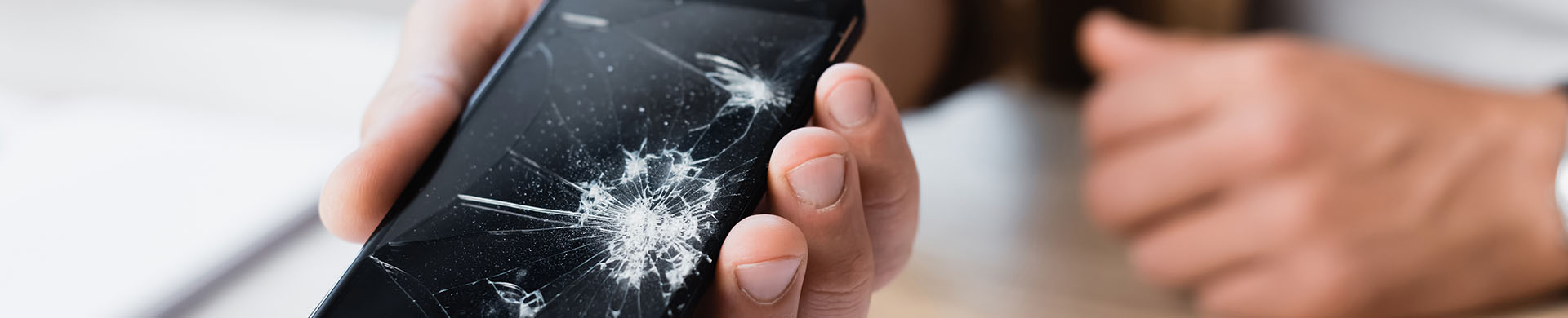 Man Holding Cracked Smartphone