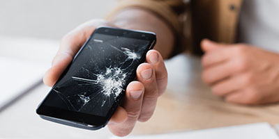 Man Holding Cracked Smartphone
