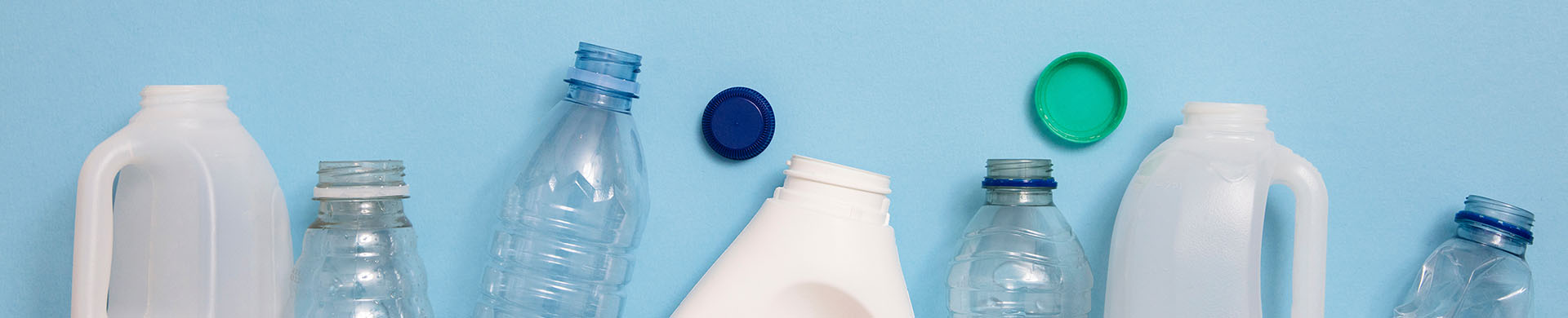 Plastic and Paper Recycling Against Blue Background