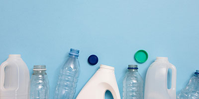 Plastic and Paper Recycling Against Blue Background