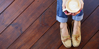 Woman Sitting On Finished Hardwood Floor