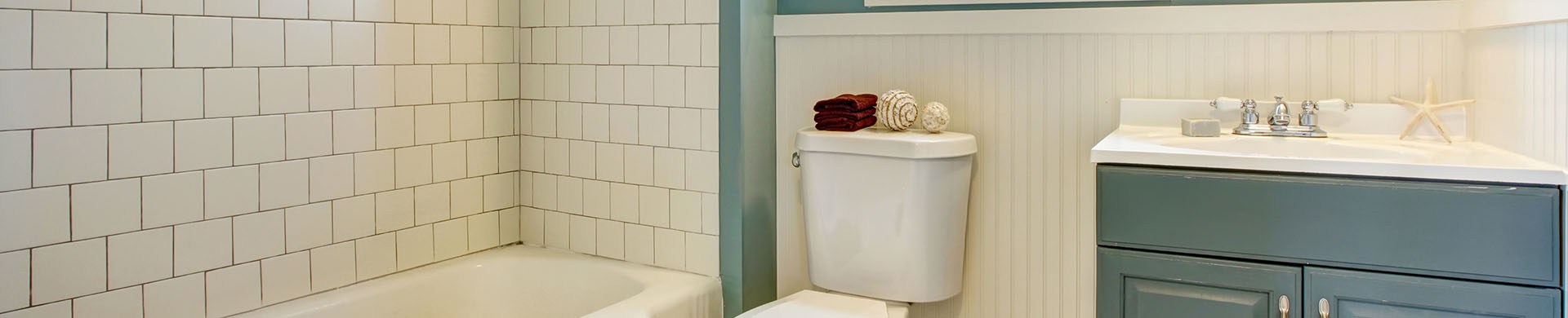 Blue Vanity in White Tiled Bathroom