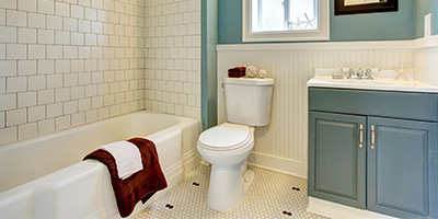 Blue Vanity in White Tiled Bathroom
