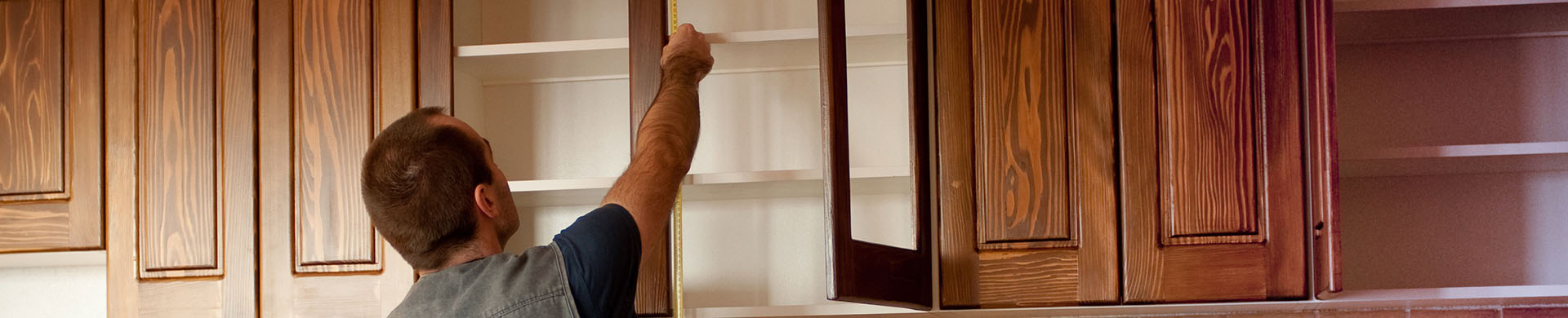 Man Removing Upper Kitchen Cabinets