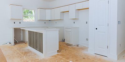 Kitchen During Remodel With Bare Walls and Appliances