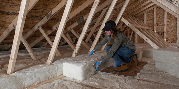 Worker Installing Rock Wool Insulation