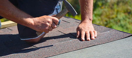 Worker Installing Roof Shingles