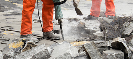 Man Using Jackhammer and Main Using Pick Axe