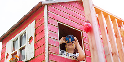 Child Looking Out of Playhouse