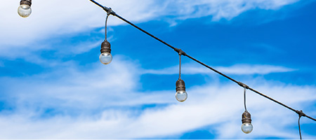 Light bulbs against the sky as an example of sustainability.