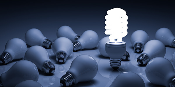 Lit Up LED Lightbulb Amongst Incandescent Bulbs