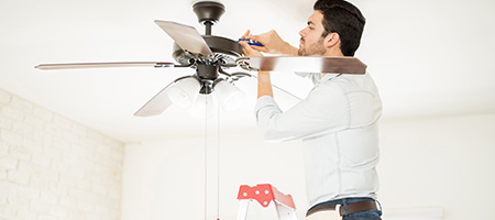 Man Adjusting Ceiling Fan
