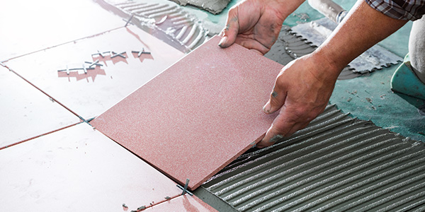 Man Laying Bathroom Floor Tiles