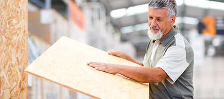 Man Measuring Wood With His Arm