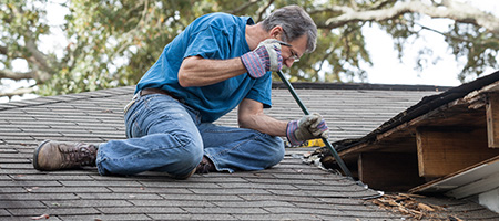 Man Repairing a Leaky Roof
