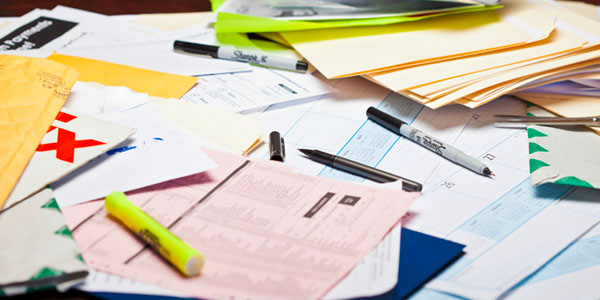 Bills, Receipts and Important Papers on a Messy Desk