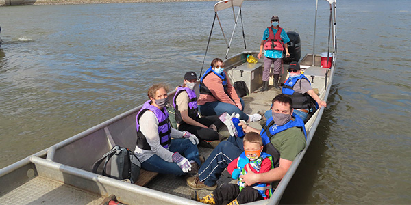 Masked Volunteers Gather on Boat