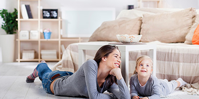 Mother and Daughter Laying on Living Room Floor